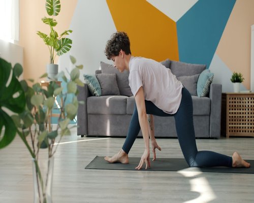 Person doing gentle stretches in a sunlit living room